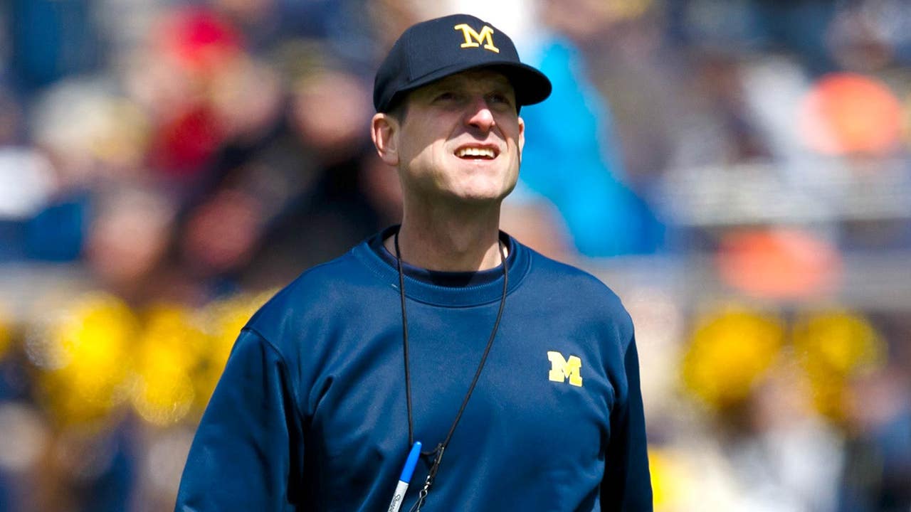 Harbaugh discusses football dreams, helmet stickers